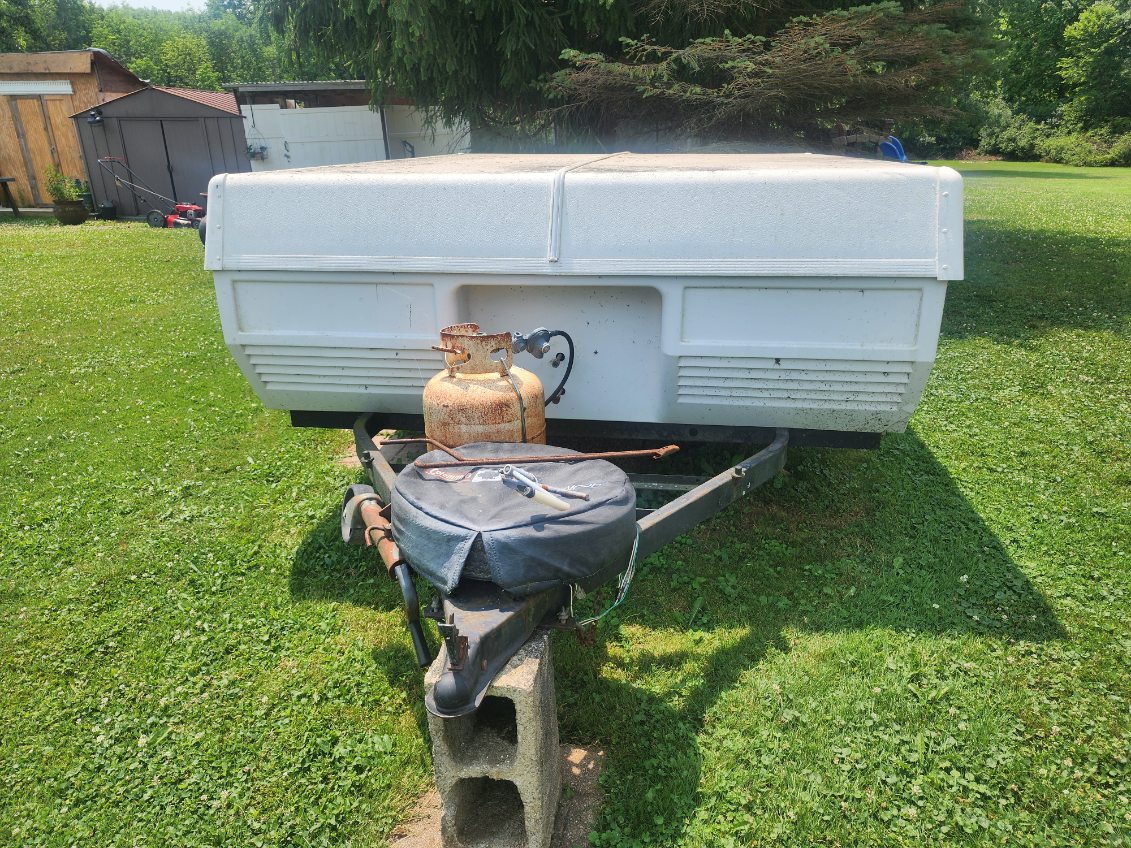 The tires are flat and dry-rotted, and the canvas has been damaged by mice. The camper has had all personal items cleaned out, and I have a clear title.