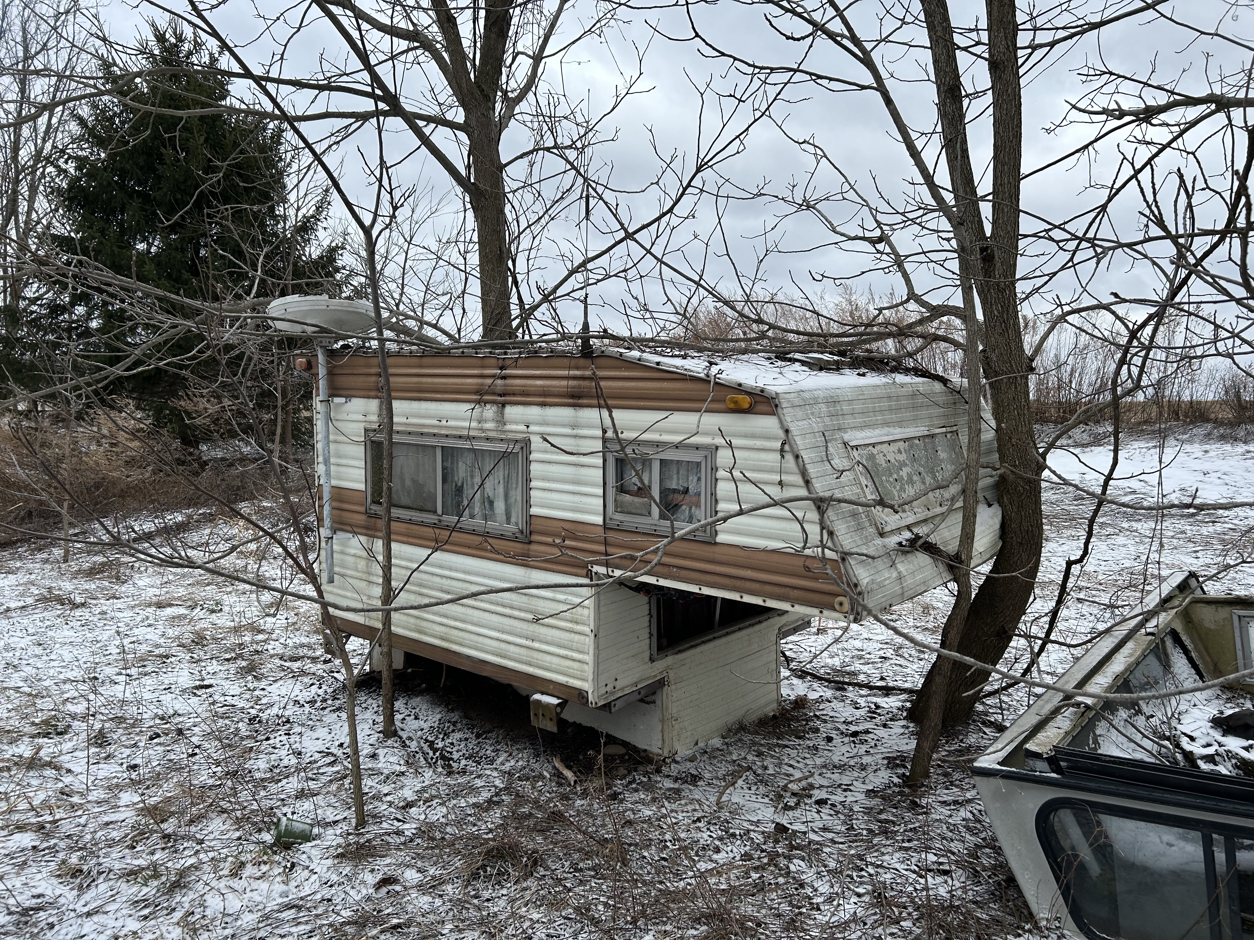 Camper that goes on the bed of a pickup truck. Been in back field for years. Town wants it gone.