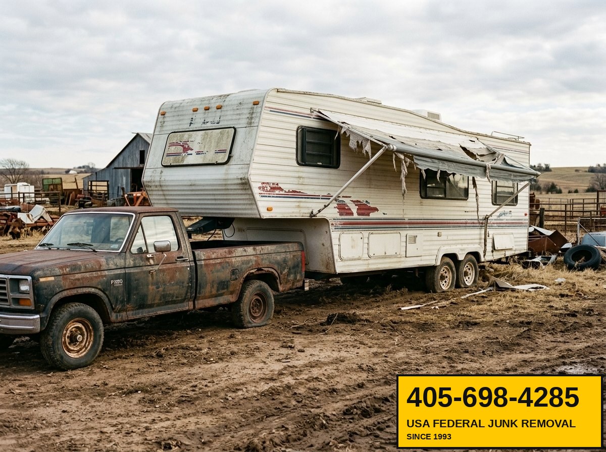 Fifth-wheel travel trailer ready for haul-off from rural farm lot